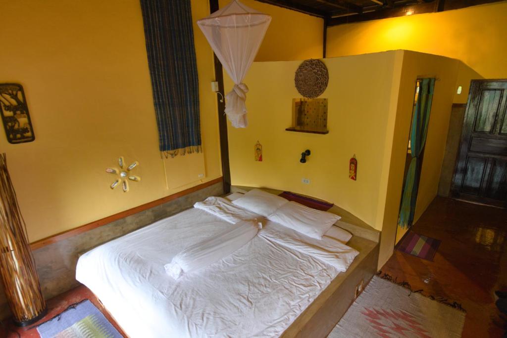 Organic river view bungalow interior with traditional Lao design and modern amenities